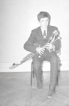 Unidentified musician playing pipes [negative] / [unidentified photographer]