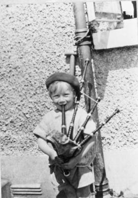 Unidentified boy playing bagpipes [negative] / [unidentified photographer]