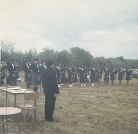 Unidentified pipe band playing in a field [negative] / [unidentified photographer]